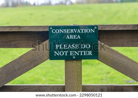 Conservation area, please do not enter sign on a wooden gate. Royalty-Free Stock Photo #2298050121