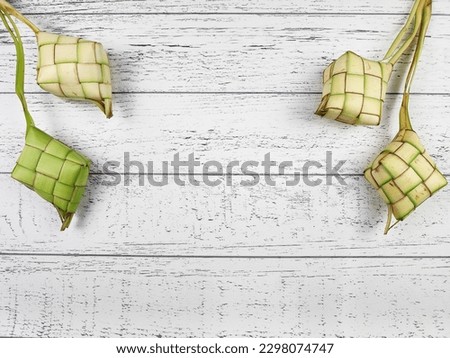 Some ketupat on a white wooden table 