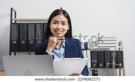 Young single female lawyer asian people in formal suit real estate working law book and contract documents, Arguments for Defense Strategy. Fight for Freedom. Supporting Evidence.