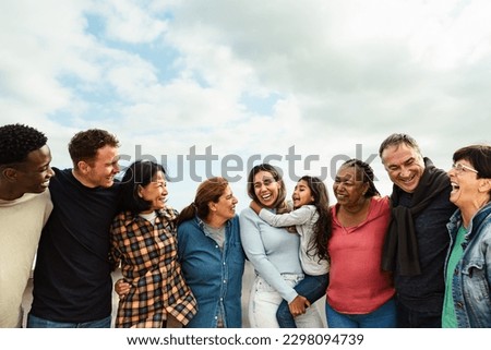 Happy multigenerational friends with different ethnicity having fun at house rooftop - Diversity people lifestyle Royalty-Free Stock Photo #2298094739