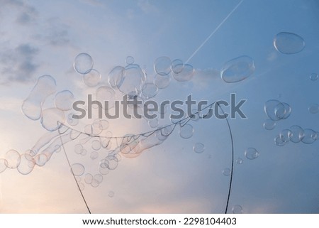 Bubbles from street entertainer on the Blue sky with clouds