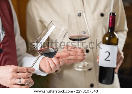Blind wine tasting, identifying different types of wines. Participants taste and identify different types of wines during a blind tasting, learning to identify the characteristics Royalty-Free Stock Photo #2298107543