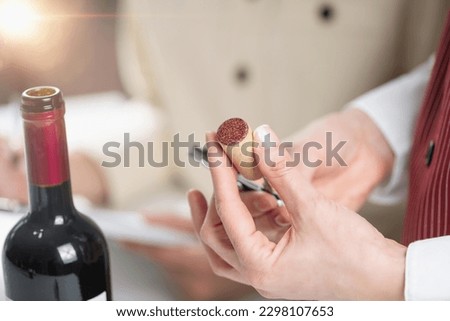 Wine tasting sensory analysis and evaluation. Wine education trainees evaluate the aroma, taste, and finish of a red wine, learning to identify its key characteristics and flaws. Royalty-Free Stock Photo #2298107653