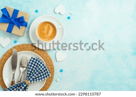 Father's day breakfast concept with coffee cup, plate  and gift box on table background. Top view from above