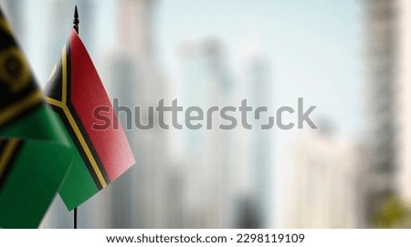 Small flags of the Vanuatu on an abstract blurry background.