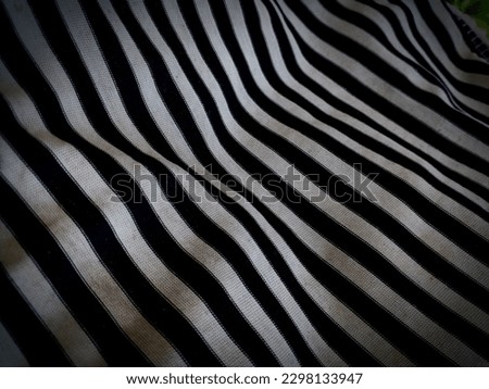 photo of a pile of stretchy fabric with a black and white color combination resembling zebra skin
