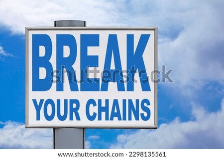 Close-up on a white billboard against a cloudy blue sky with the message "Break your chains" written in the middle.