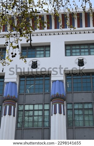Ornate and colourful façade of art deco style factory with Egyptian style ornamentation on former 1930s Carreras Cigarette Factory in Camden Town, London, England, UK