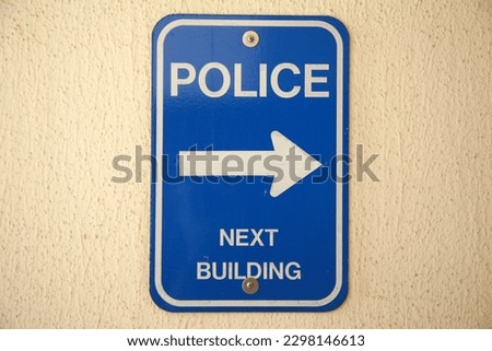 POLICE next building sign. Blue POLICE next door metal sign on a wall. Huntington Beach California Police Sign. City Civic Center Police Sign. Cops are very important.
