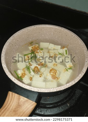 Tofu clear soup: a healthy budget meal consist of tofu, scalions, fried shallots, and chicken stock broth