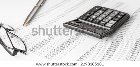 Calculator on financial statement and balance sheeet on desk of auditor. Concept of accounting and audit business.