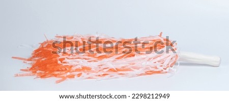Orange and white pompom isolated on studio background