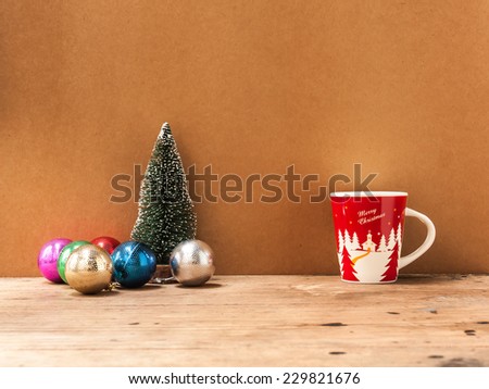 cup of coffee  with ball and tree on wooden background,decoration for Christmas Holiday.