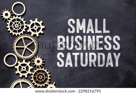 Small Business Saturday typography text on the blackboard set on wooden floor and brick background Royalty-Free Stock Photo #2298216795