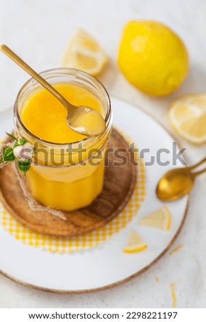 Homemade lemon curd on a light background