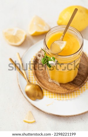 Homemade lemon curd on a light background