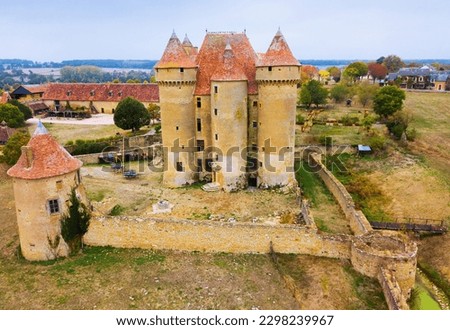 Picturesque autumn landscape with imposing medieval fortress Chateau de Sarzay, France..