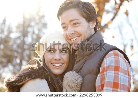Their love is warm and bright like autumn leaves. A loving young couple embracing outside.