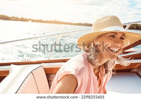Loving life out here. a mature woman enjoying a relaxing boat ride. Royalty-Free Stock Photo #2298255601