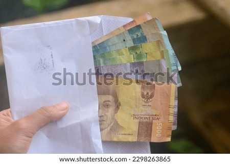 looks at the means of payment in Indonesia. Indonesian money is called rupiah. used as legal tender. not only to buy, money can also be used as a gift from other people.