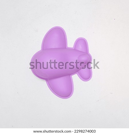 purple plastic airplane toy with white background
