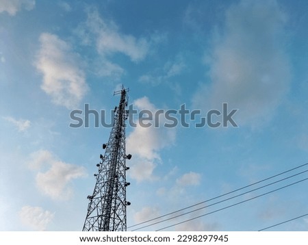 Bottom view of telephone signal tower. Indonesian network provider tower with blue sky background.