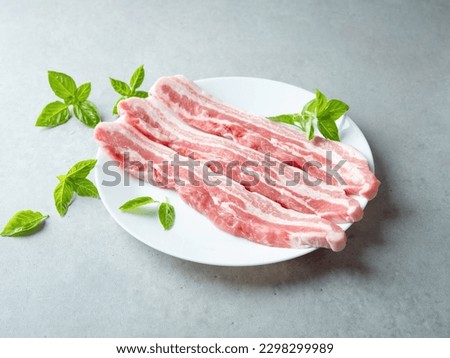 Raw pork belly on a plate Royalty-Free Stock Photo #2298299989