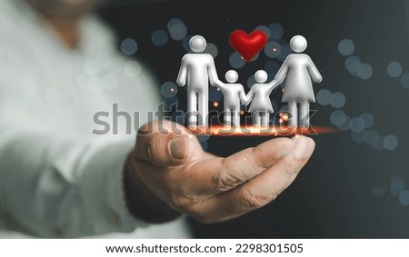 Hands holding 3D virtual family icon. Security protection and health insurance. The concept of family home, foster care, homeless support, protection, health care day and home school education
