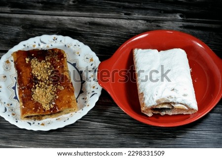 Apple pie stuffed with creamy apple, cinnamon and sugary sweet honey syrup and topped with pistachios, nuts and icing sugar, delicious sweetened baked apple pie ready to be served, selective focus