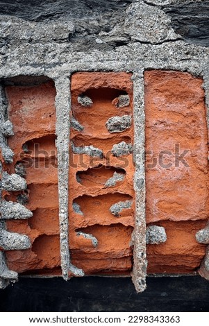 traditional Cornish wall building material worn away by the salt water from the sea - Port Isaac village  Royalty-Free Stock Photo #2298343363