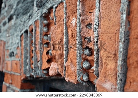 traditional Cornish wall building material worn away by the salt water from the sea - Port Isaac village  Royalty-Free Stock Photo #2298343369