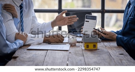 Closeup of Happy asian couple customers sign mortgage loan contract. Making lease and buy and sell house And contract home insurance mortgage loan concept Royalty-Free Stock Photo #2298354747