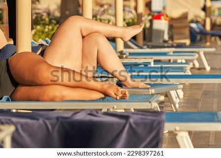 Picture of plus size legs on sunbed in resort