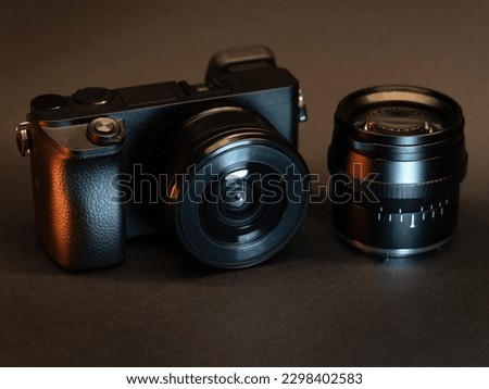 photo camera with an additional lens on a dark background