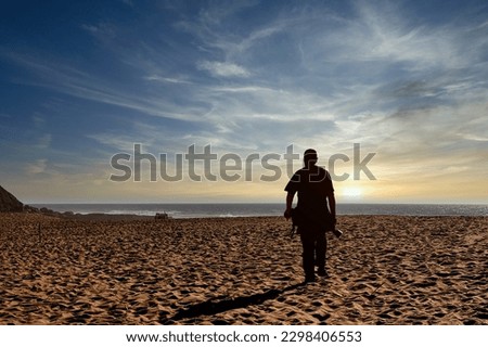 A photographer on the beach at the end of the evening