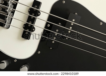 Closeup photo of a white bass guitar. Music wallpaper
