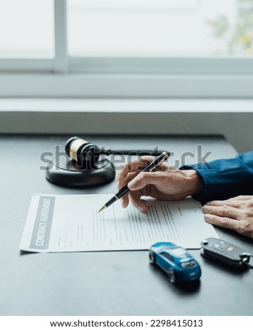 Car insurance agent consulting with policy and contract to approved stamp rubber after signing.