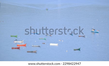 Colorful fishing boats in the sea photographed from above