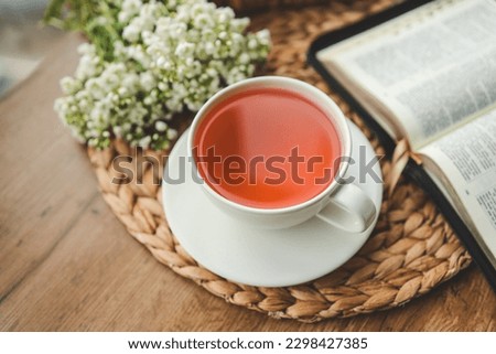 Cup of tea, open bible and flowers, good morning.