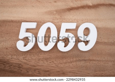 White number 5059 on a brown and light brown wooden background.
