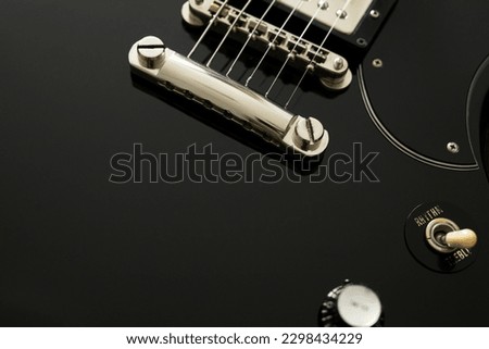Photo of a black electric guitar. Music background.