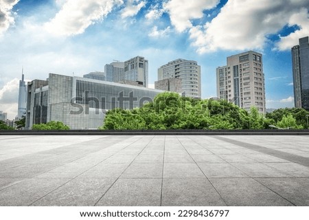 Empty foreground square and city buildings background