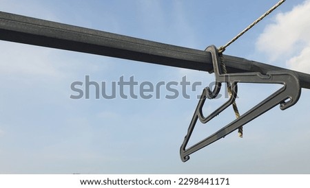 photo of clothes hanger against blue sky background