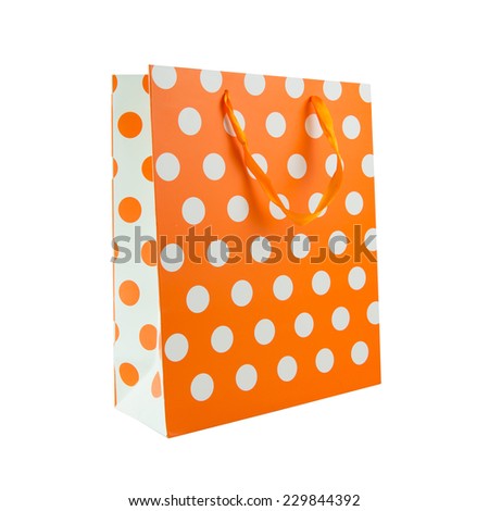 Orange polka dot gift bag isolated on white background