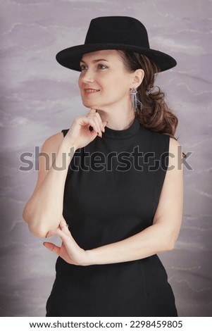 Portrait of a girl in a black hat