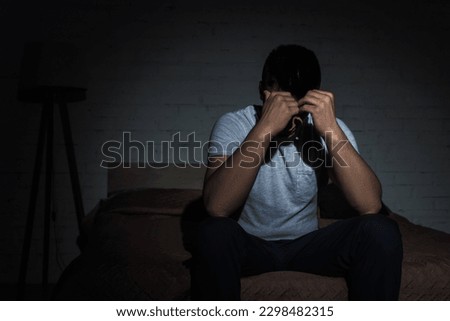 depressed man with insomnia struggling from post traumatic stress disorder Royalty-Free Stock Photo #2298482315