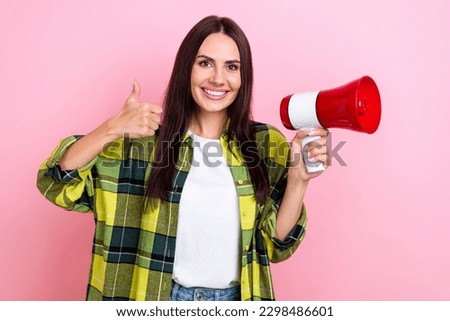 Portrait of good mood optimistic person long hairstyle wear plaid shirt showing like hold megaphone isolated on pink color background