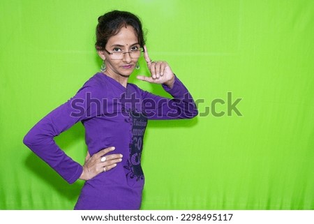 Capture a versatile image of a cute, smart girl sporting stylish spectacles, posing as a fashion model against a green screen background. Great for commercials and editorials. Ready to use!