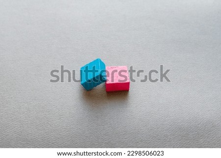 Closeup picture of colorful wooden toy blocks on grey background