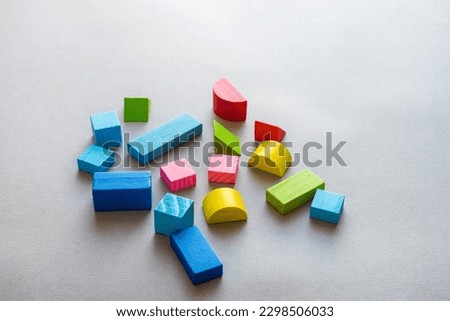 Closeup picture of colorful wooden toy blocks on grey background